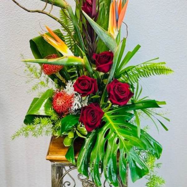Tropical arrangement with red roses and bird of paradise flowers