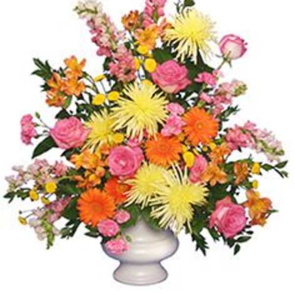 Colorful mixed flower arrangement in a white vase