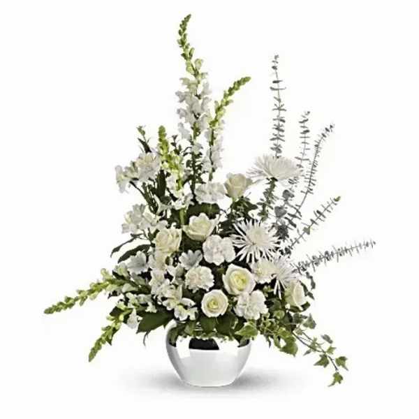 White floral arrangement in a white vase with tall spiky accents