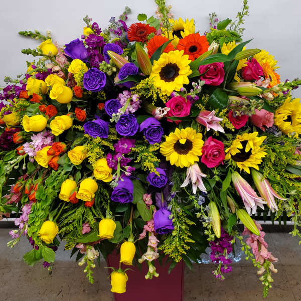 Large mixed bouquet with roses, sunflowers, lilies, and snapdragons
