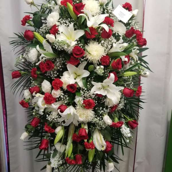 Large standing spray of red roses and white lilies with white chrysanthemums