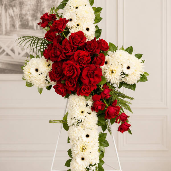 Standing floral cross with red roses and white daisies on an easel