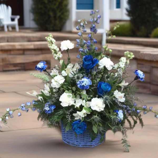 Blue and white floral arrangement in a blue basket