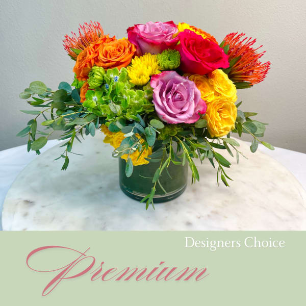 Colorful mixed bouquet of roses and mums in a green vase