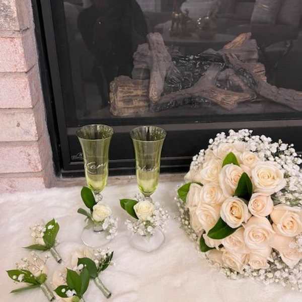 Cream rose bouquet with matching boutonnieres and champagne flutes