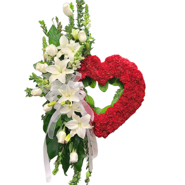 Heart-shaped red floral wreath with white lilies and roses