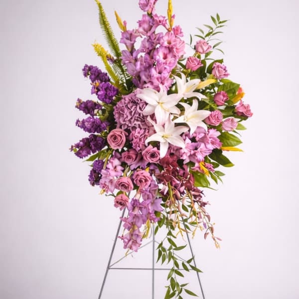 Tall floral spray with pink, purple, and white blooms on a metal stand