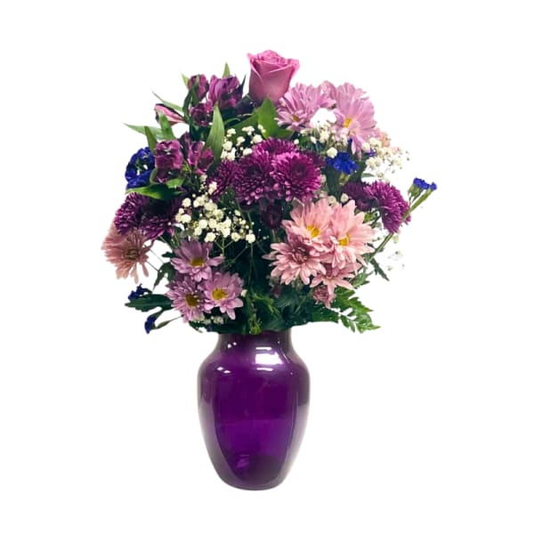 Purple and pink mixed bouquet in a purple vase