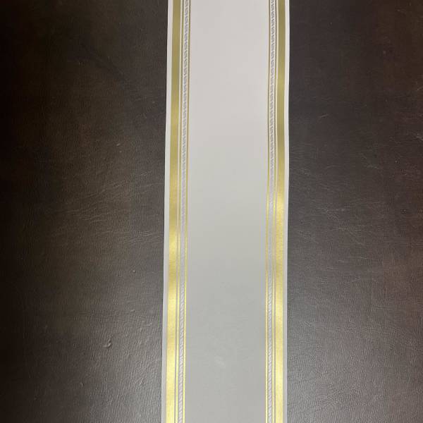 White ribbon with gold and silver decorative borders