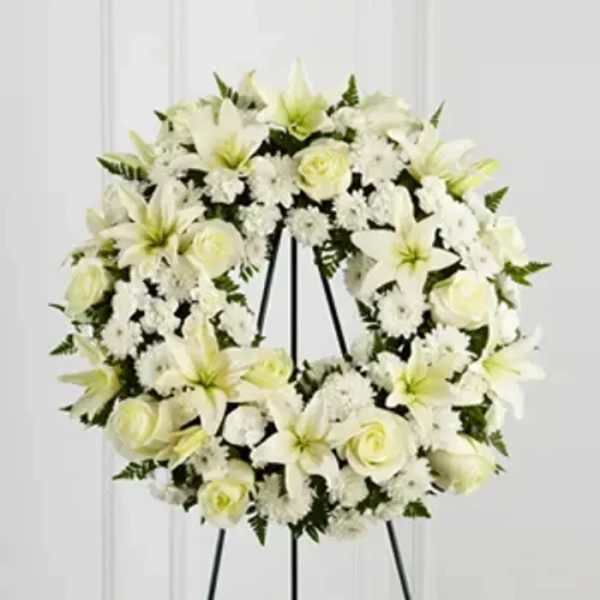 White floral wreath on a black easel