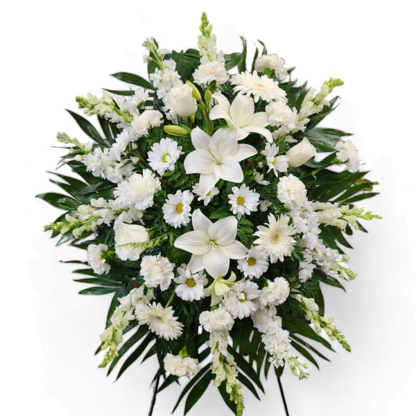 White funeral spray with lilies, daisies, and carnations
