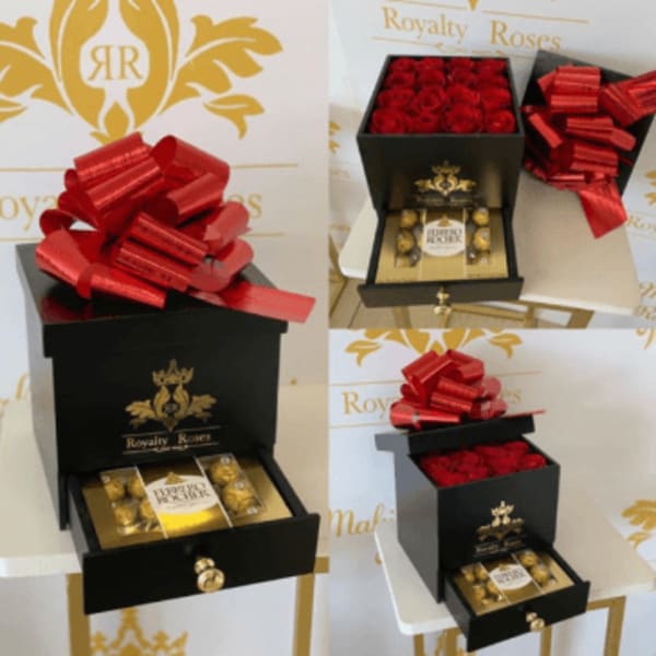 Black gift box with red roses and a red bow, plus chocolates in a drawer.
