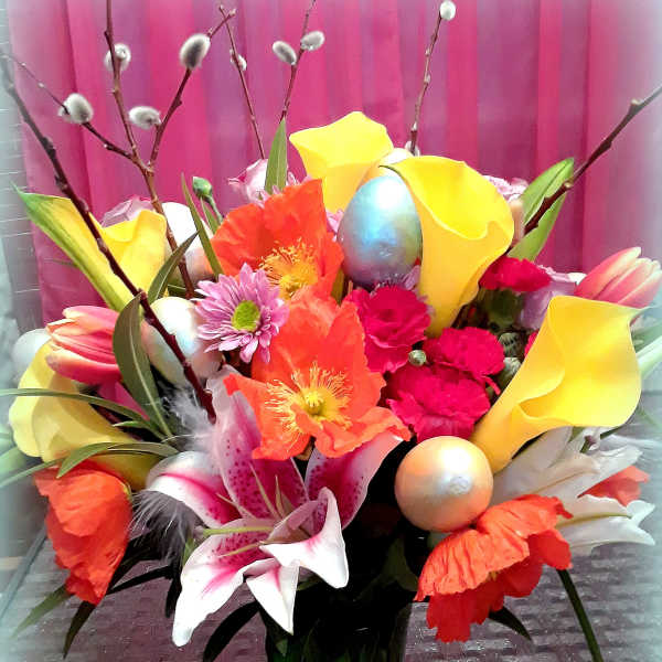 Colorful bouquet with calla lilies, lilies, and poppy-like blooms