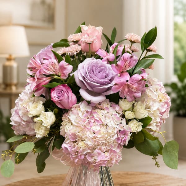Pink and lavender bouquet with roses, hydrangeas, and alstroemeria in a metallic vase