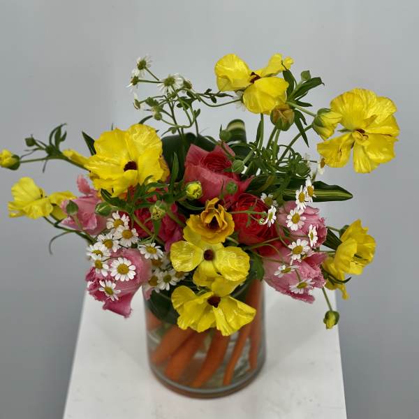 Bouquet of yellow and pink flowers in a glass vase