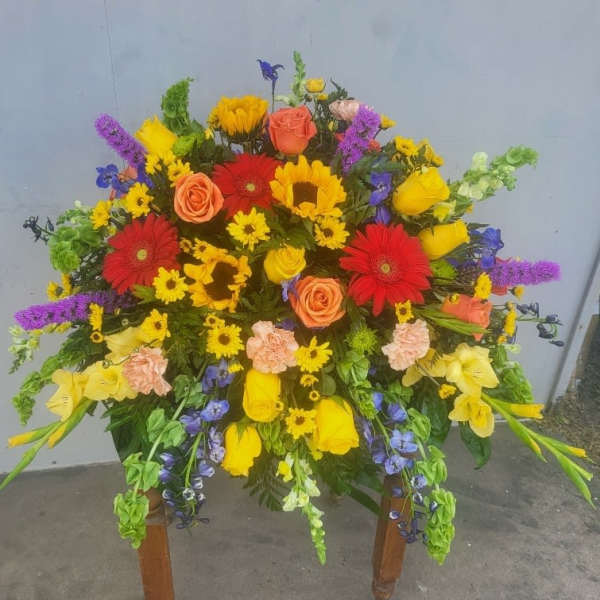 Large mixed bouquet with roses, gerbera daisies, sunflowers, and purple accents