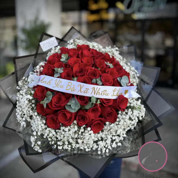 Large bouquet of red roses with white baby's breath and a ribbon banner