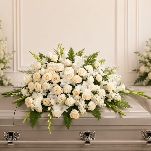 White and cream floral casket spray with roses and lilies