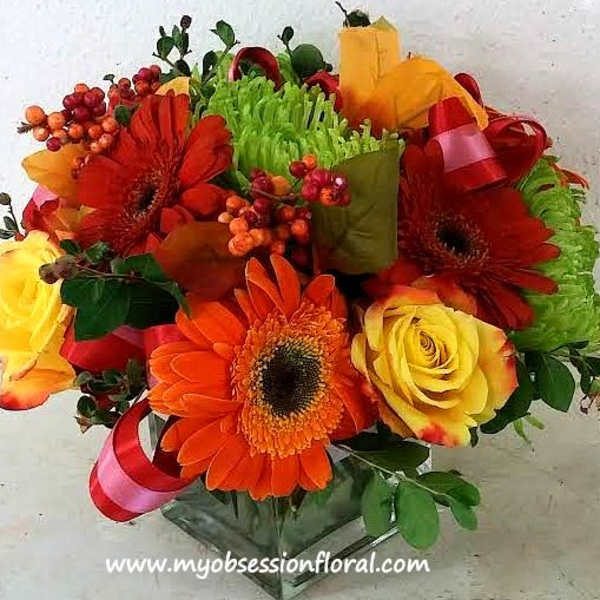 Bouquet of orange gerbera daisies and yellow roses with ribbon