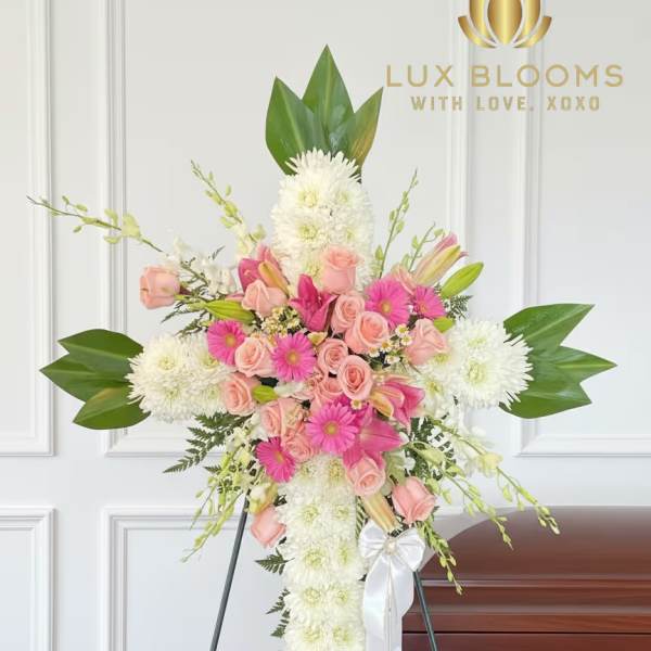 Standing floral spray with pink roses and white chrysanthemums on an easel