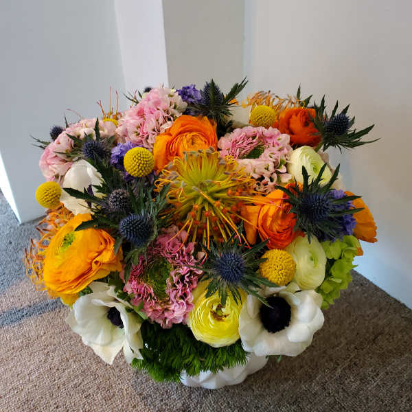 Colorful mixed bouquet with orange, pink, white, and yellow blooms