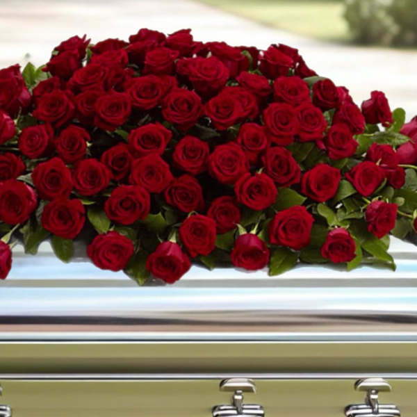 Large spray of red roses on a casket