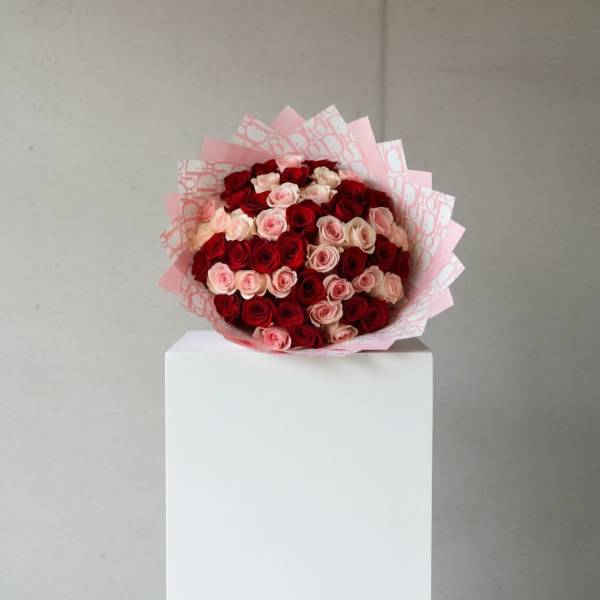 Bouquet of red and pink roses wrapped in pink paper