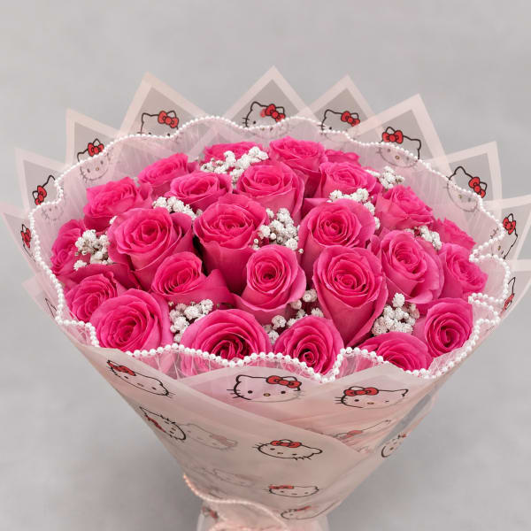 Bouquet of bright pink roses wrapped in Hello Kitty paper