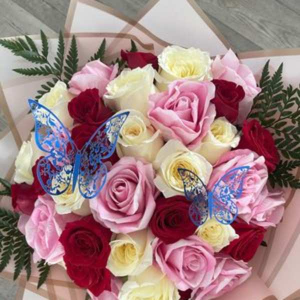 Bouquet of pink, red, and white roses with blue butterfly picks