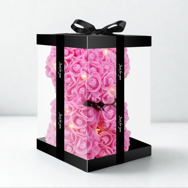 Pink rose-shaped floral gift box with a black ribbon bow