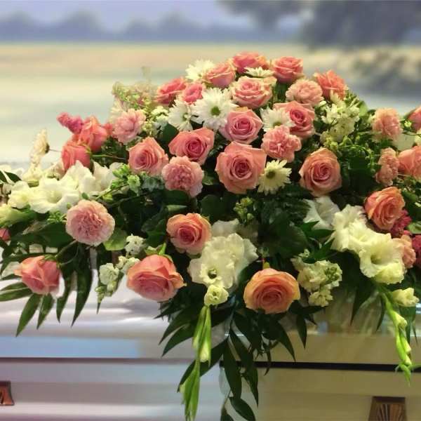 Large pink and white floral casket spray with roses and carnations