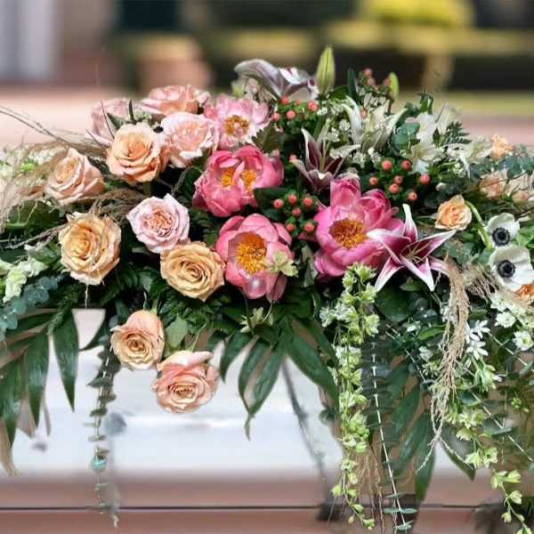Large floral arrangement with pink and peach roses and lilies