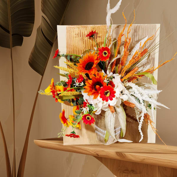 Bright orange and red floral arrangement with white accents in a decorative display