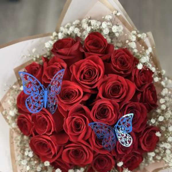 Bouquet of red roses with white baby's breath and blue butterfly picks