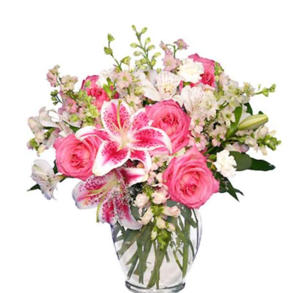Pink roses and lilies in a clear glass vase