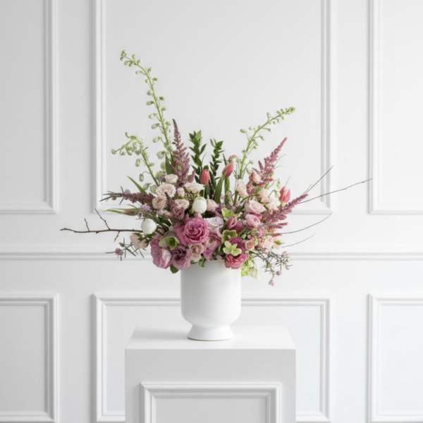 Pink and white floral arrangement in a white vase