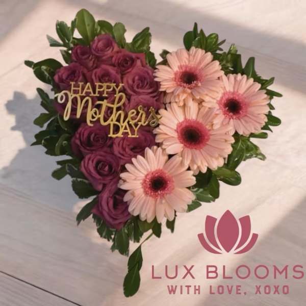 Heart-shaped bouquet of purple roses and pink gerbera daisies with a Mother's Day sign