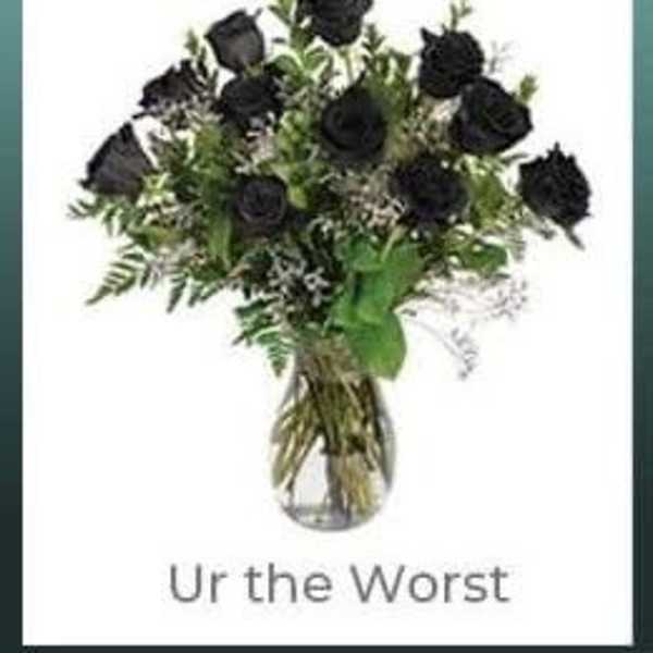 Bouquet of black roses in a clear glass vase with text below