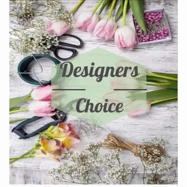 Flat lay of pink tulips, filler flowers, and florists' tools around a Designers Choice label