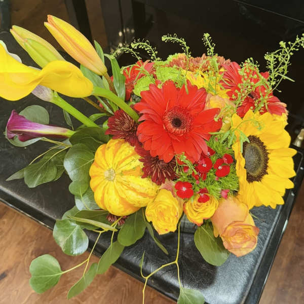 Bright mixed bouquet with sunflowers, gerbera daisies, roses, and calla lilies