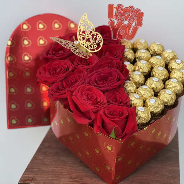 Heart-shaped box with red roses and gold-wrapped chocolates