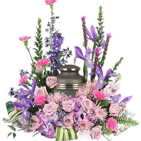 Floral funeral urn arrangement with pink and purple flowers