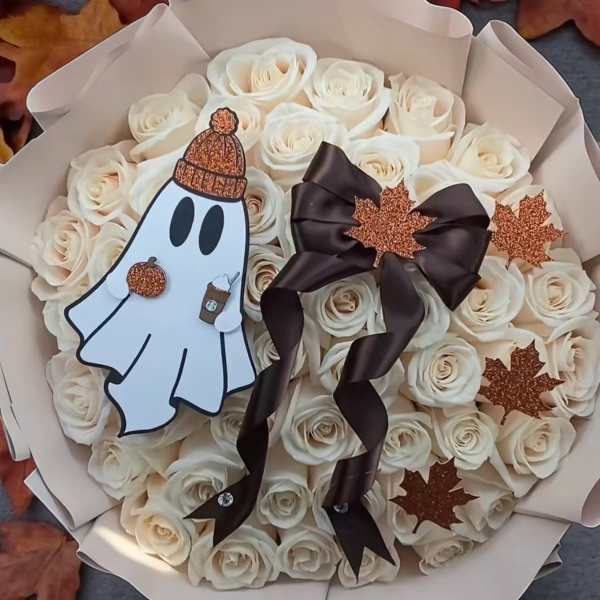 Bouquet of white roses with a ghost decoration and dark ribbon