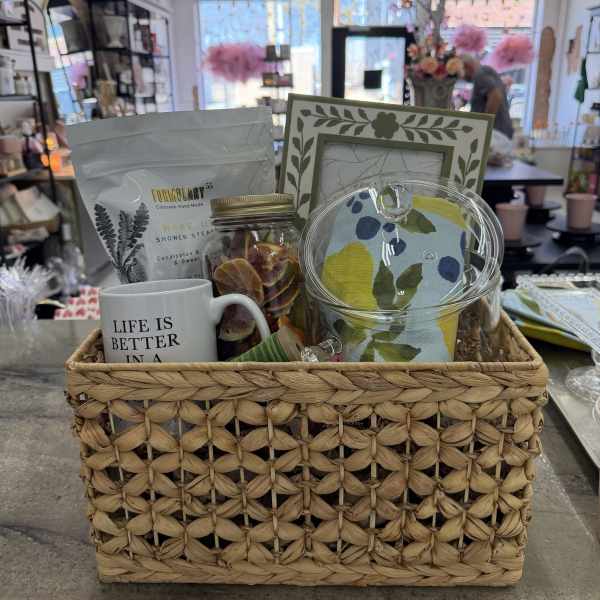 Gift basket with a mug, tea, candle, and decorative items