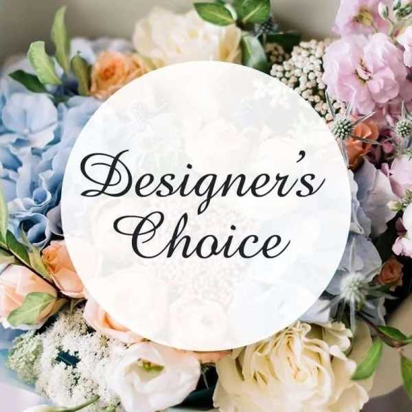 Floral arrangement with pastel blooms and a "Designers' Choice" sign