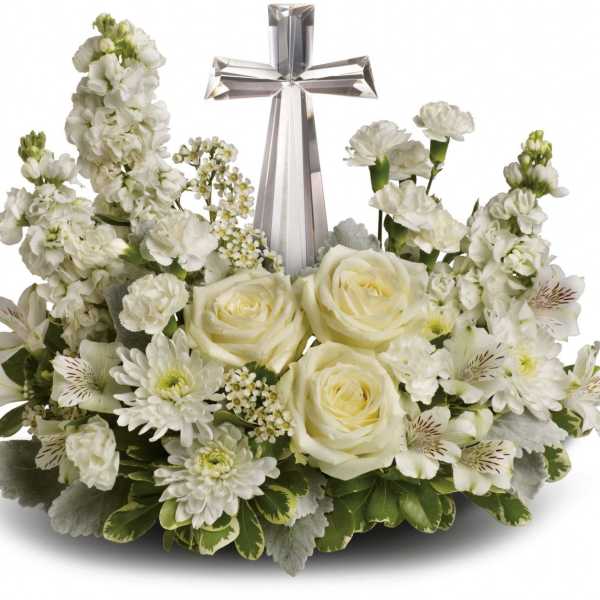 White floral arrangement with a silver cross centerpiece
