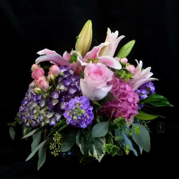 Pink lilies, roses, and purple hydrangeas in a bouquet