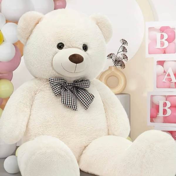 Large white teddy bear with a black checkered bow, surrounded by pastel balloons