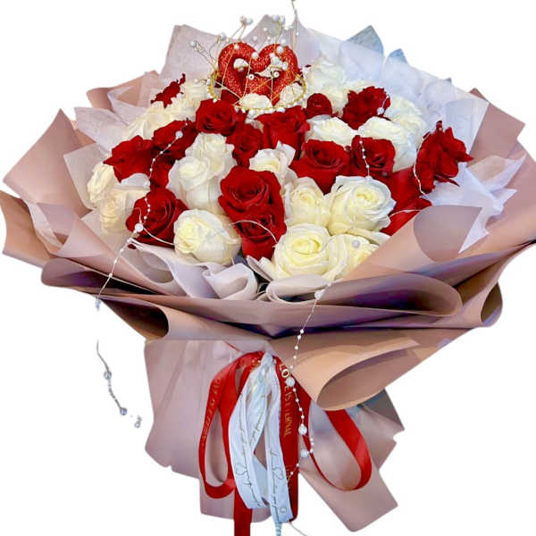 Bouquet of red and white roses with a heart topper and ribbon wrap