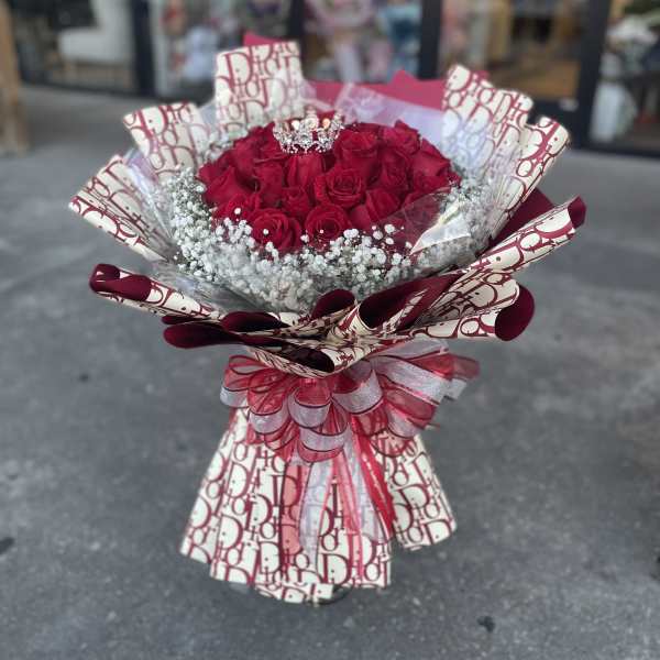 Bouquet of red roses with baby's breath and a decorative ribbon